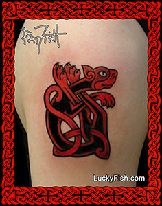 Tattoo of a red and black Celtic knot cat tattoo design on skin, with 'Lucky Fish' branding.