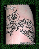 Black floral tattoo on a person's arm with 'Lucky Fish' branding.