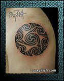 Tattoo of a black spiral Celtic design on a person's arm with 'Lucky Fish' branding.