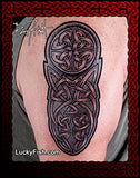 Celtic tattoo design by Pat Fish on a person's arm with LuckyFish.com branding.