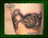Tattoo of a Celtic knot design of cats from the 9th c Book of Kells on skin with Lucky Fish branding and Pat Fish signature.