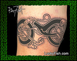 Tattoo of a cat and knot design on skin with Lucky Fish.com branding.
