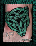 Green Celtic knot tattoo on the top of a foot with 'Lucky Fish' branding.