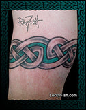 Celtic knot tattoo band on a person's arm with 'Lucky Fish' branding.
