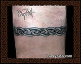 Tattoo of a Celtic knot design arm band with 'Lucky Fish' branding.