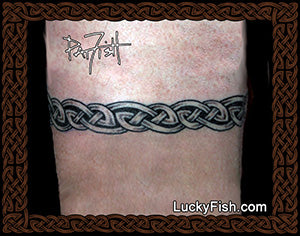 Tattoo of a Celtic knot design arm band with 'Lucky Fish' branding.