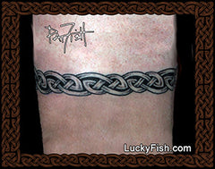 Tattoo of a Celtic knot design arm band with 'Lucky Fish' branding.