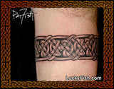 Celtic knot tattoo on a person's arm armband tattoo by Pat Fish and 'Lucky Fish' branding.