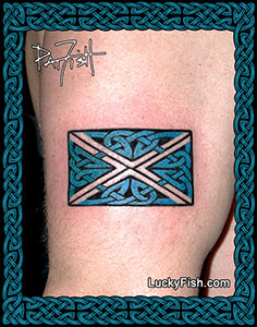 Tattoo of a Scottish flag Saltire with Celtic knot design on a person's arm with a signature of artist Pat Fish.