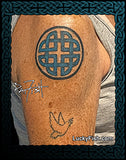 Person with a round Celtic knot tattoo on their arm with 'Lucky Fish' branding.