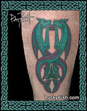 Tattoo of two interlocking mer horses in teal and purple on a person's arm, with Lucky Fish branding.