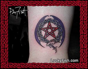 Tattoo of a pentagram with a dragon in a wreath on a person's arm, framed by red Celtic knotwork and featuring 'Lucky Fish' branding.