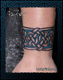 Celtic knot tattoo on a person's wrist with Lucky Fish branding.
