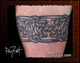 Celtic knot tattoo armband  on a person's arm with 'Lucky Fish' branding.