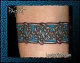 Celtic knot tattoo on a person's arm with 'Lucky Fish' branding.