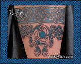 Celtic knot arm band Tattoo design on skin with intricate patterns added belowr, featuring the brand 'Lucky Fish'.