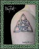 Celtic knot tattoo on shoulder with 'Lucky Fish' branding.