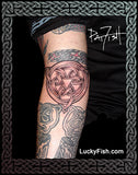 Tattoo of a Celtic knot design on a forearm with 'Lucky Fish' branding.