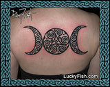 Tattoo of a Celtic triple moon symbol on a person's back with 'Lucky Fish' branding.