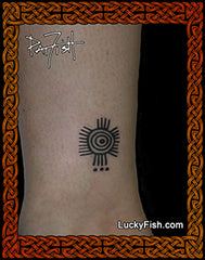 Tattoo of a Peruvian Inca sun design on a person's ankle with 'LuckyFish.com' branding.