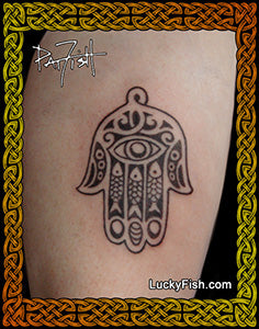 Hamsa hand tattoo by Pat Fish on a person's arm with 'Lucky Fish' branding.