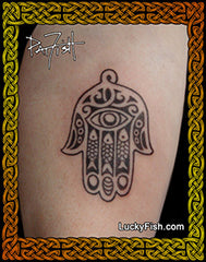Hamsa hand tattoo by Pat Fish on a person's arm with 'Lucky Fish' branding.