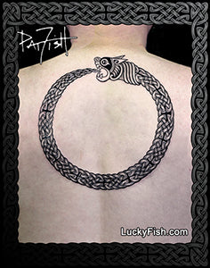 A black and white Celtic knot design of an ouroboros snake wrapping in a circle, presented as an upper backpiece tattoo.