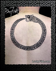 A black and white Celtic knot design of an ouroboros snake wrapping in a circle, presented as an upper backpiece tattoo.