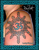 A close-up of a person's upper shoulder with a large black and blue Celtic knot sun and Om symbol tattoo. The image is framed by a decorative teal Celtic border, with a 'Pat Frost' signature in the top right and 'LuckyFish.