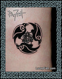 Black tattoo of three ravens with a Celtic knot design on a person's arm, framed and with LuckyFish branding by Pat Fish