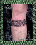 Celtic tattoo band on a person's leg by Pat Fish