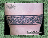 Celtic knot tattoo armband on a person's arm with Lucky Fish branding.