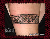 Celtic knot tattoo band on a person's arm with LuckyFish.com branding.