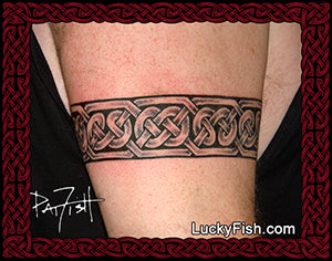 Celtic knot tattoo band on a person's arm with LuckyFish.com branding.