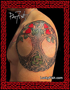 Tattoo of a Celtic tree of life design on a shoulder with knotwork and hearts and 'LuckyFish.com' branding.
