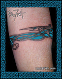 Tattoo of a fNordic dragon armband  on a person's arm, featuring Lucky Fish branding.