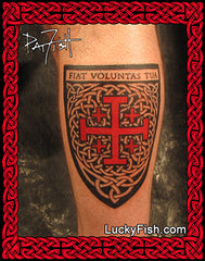 Tattoo of a red JERUSALEM cross with 'Fiat Voluntas Tua' text on a person's arm, tattooed by Pat Fish of LuckyFish.com