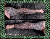 Tattooed arms with intricate designs of Celtic knotwork and featuring Lucky Fish Tattoo branding.