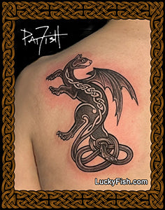 Celtic winged cat tattoo on a person's shoulder with 'Lucky Fish' branding.