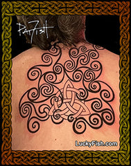 A photo of a person's back showing a spiral tattoo design, with intricate Pictish spiral patterns.